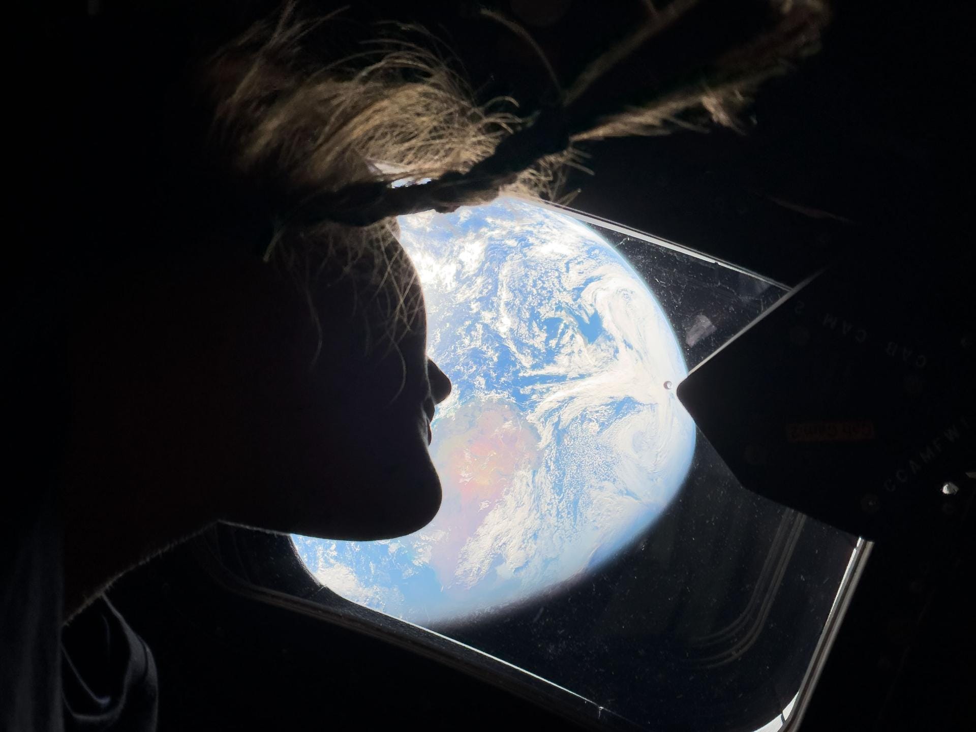 NASA astronaut Christina Koch peers out of the Orion spacecraft